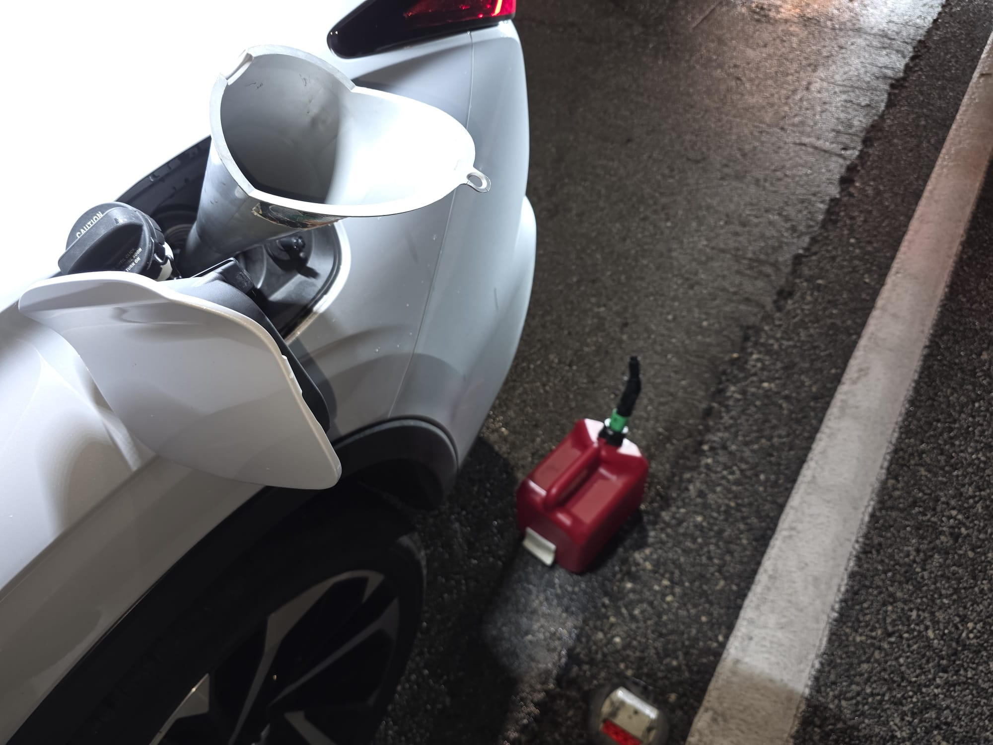 Fuel can and funnel at a stranded vehicle — fuel delivery service