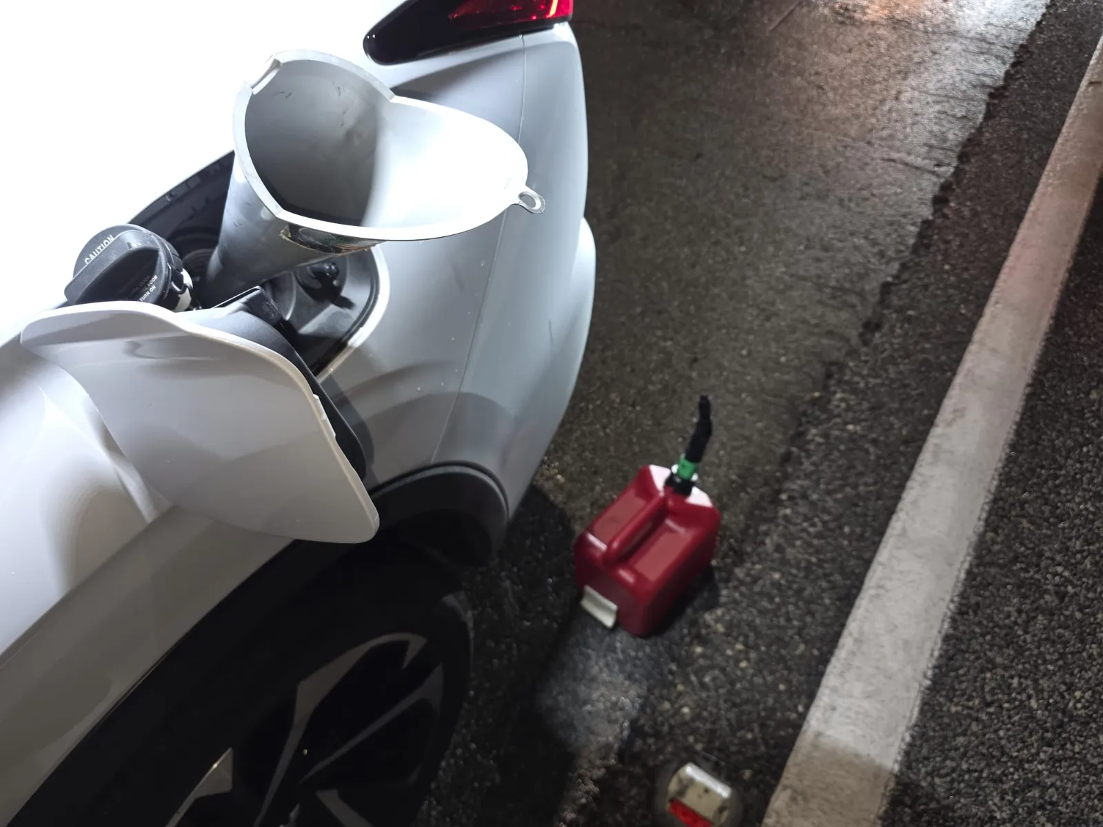 Fuel can and funnel at a stranded vehicle — fuel delivery service