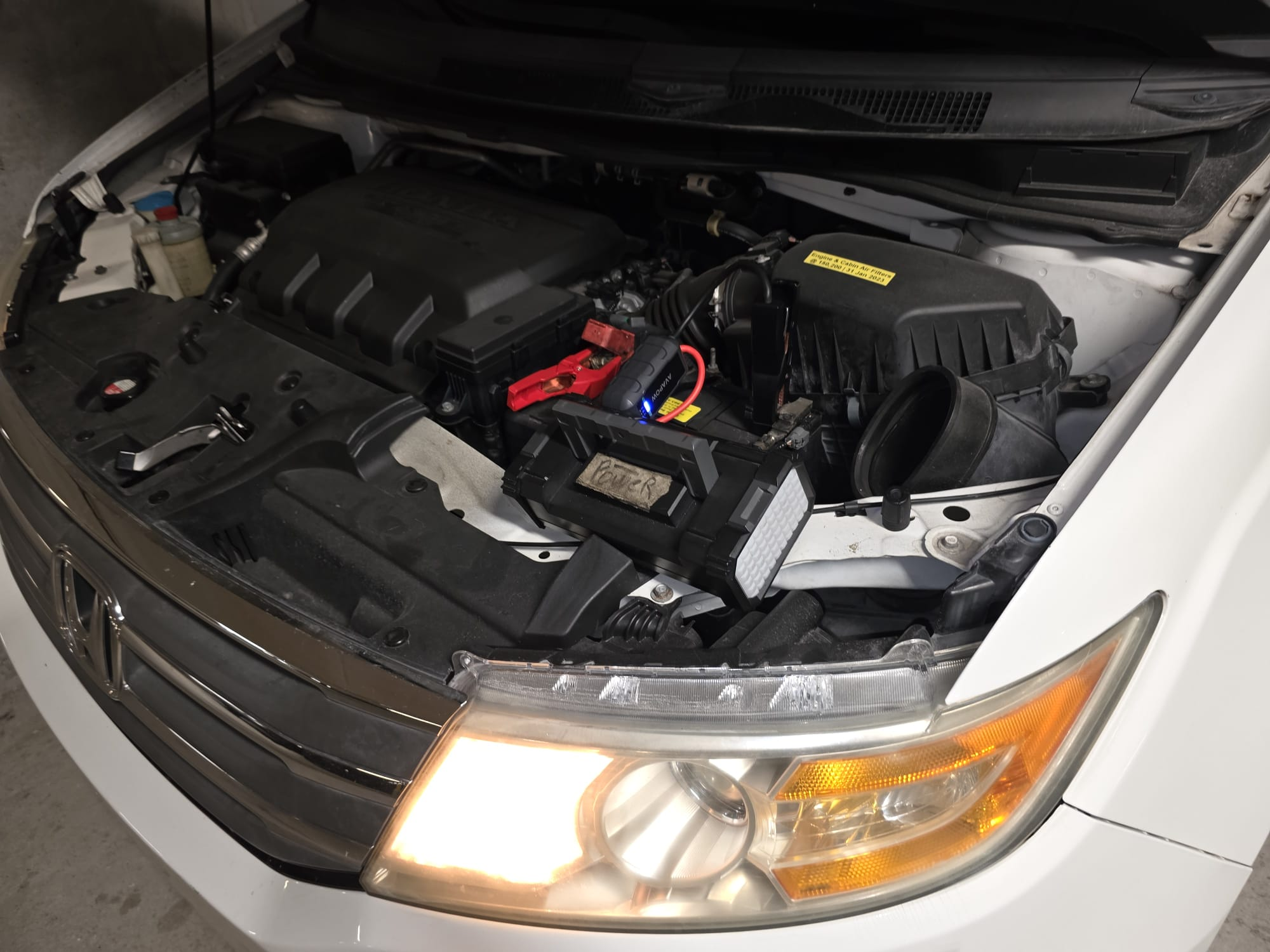 Portable jump-start pack reviving a stalled engine