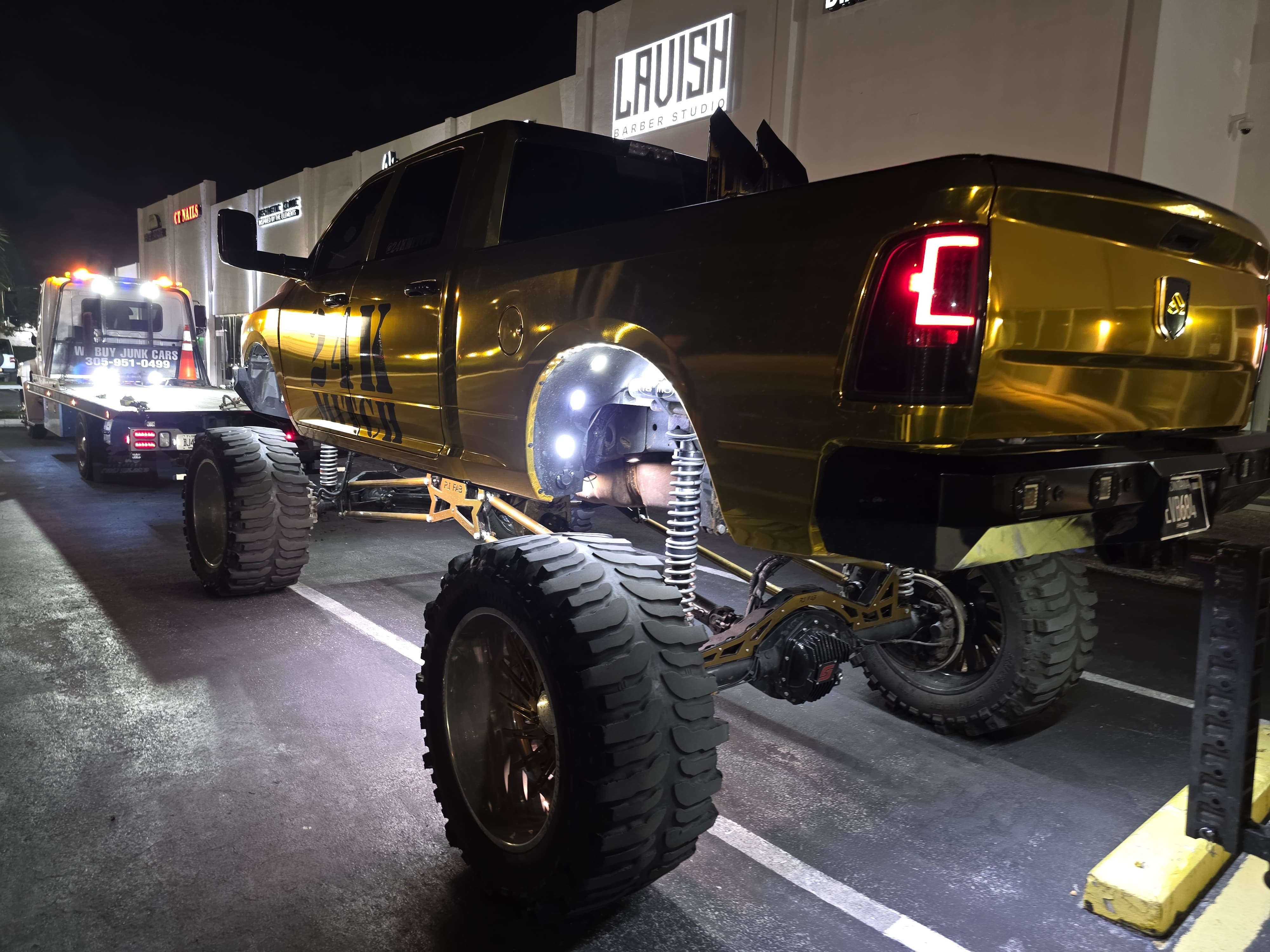 Custom gold lifted truck on a specialty transport