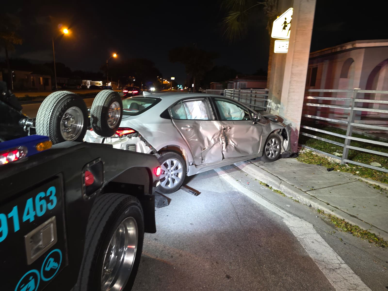 Damaged Toyota Corolla recovered from an accident scene at night