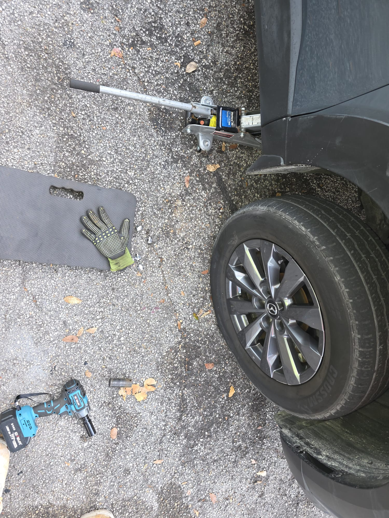 Roadside tire change on a Mazda SUV