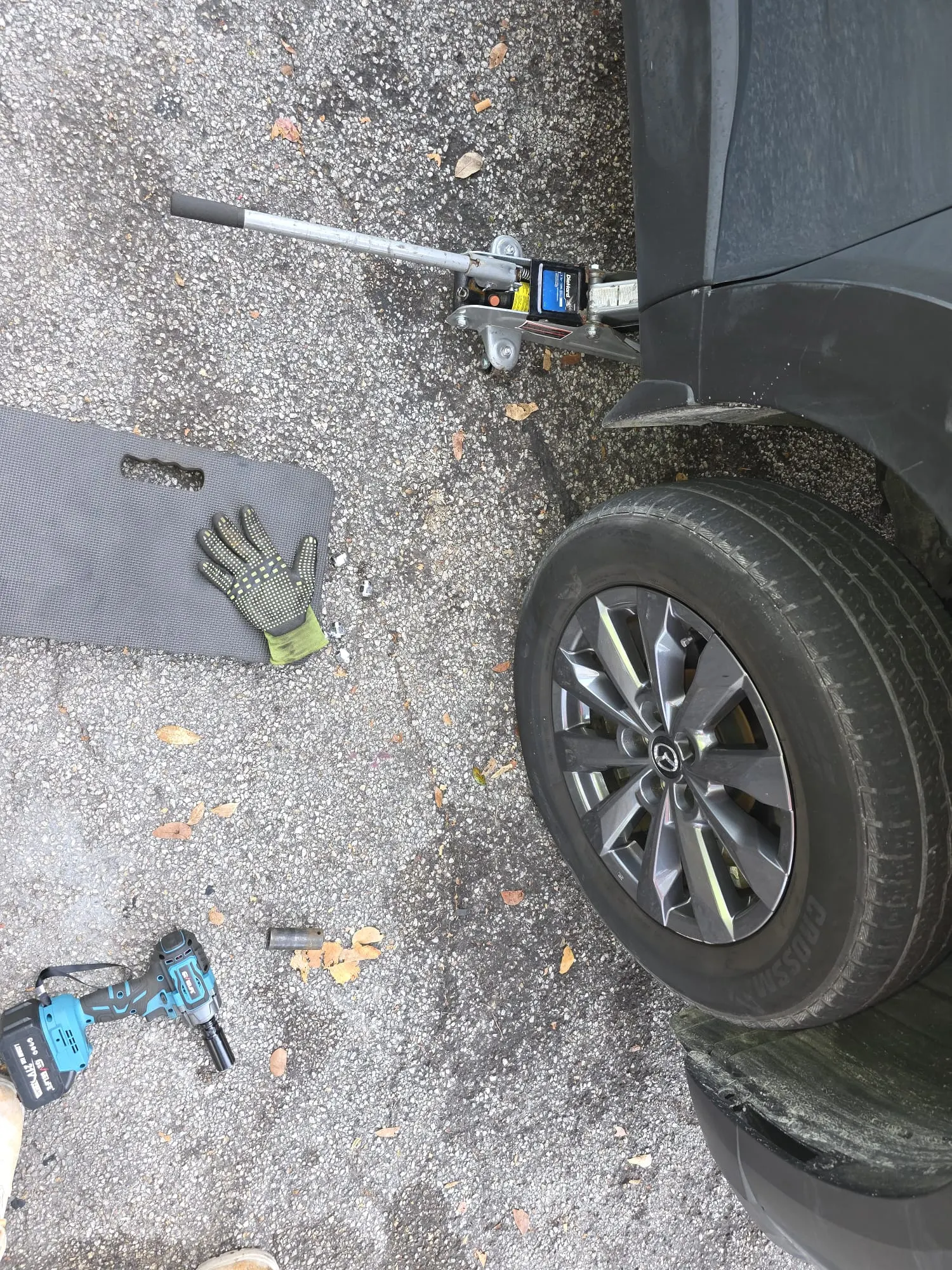 Roadside tire change on a Mazda SUV